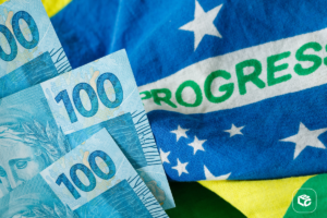 Notas de 100 reais sobre a bandeira do Brasil com a palavra PROGRESSO